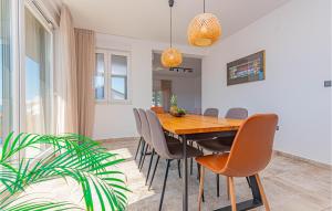 a dining room with a wooden table and chairs at Beautiful Home In Zaboric in Zaboric