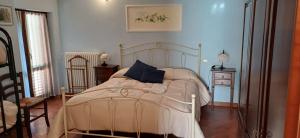 a bedroom with a white bed with a blue pillow at Al Vecchio Camino in Rotonda