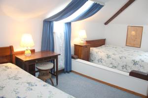 a bedroom with two beds and a tub and a desk at Barony Agave in Lugano +16 photos