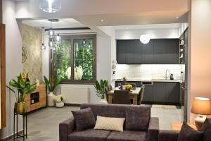 a living room with a couch and a kitchen at Nychome in Ayía Marína