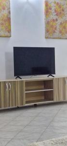 a flat screen tv sitting on top of a entertainment center at SEED-Aeroport Nsimalen Yaounde in Nsimalen
