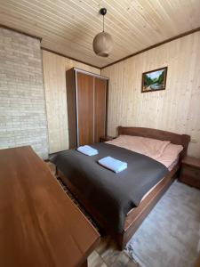 a bedroom with a large bed with two pillows on it at Five House in Skhidnitsa