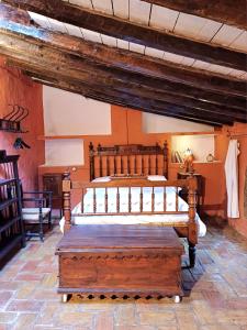 a bedroom with a wooden bed in a room at La Querala in Cabanes