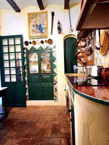 a kitchen with a green door and a counter at La Querala in Cabanes +33 photos