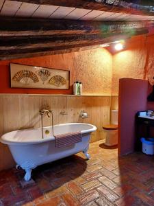 a large bath tub in a room with a toilet at La Querala in Cabanes