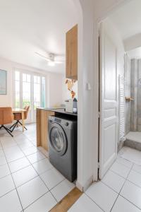 une cuisine avec une machine à laver dans une pièce dans l'établissement Cocon comfortable vue mer, Clim et parking, à Sanary-sur-Mer