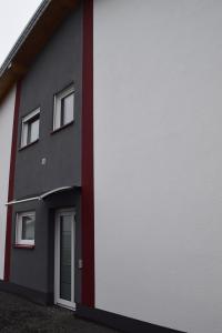 un edificio rosso e bianco con una porta di Ferienhaus 2 - 55471 Reich - EG - OG a Reich