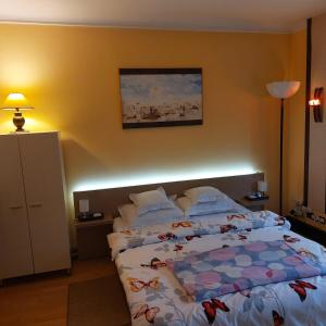 a bedroom with a large bed with pillows on it at Casa Negoiu in Târgu-Mureş