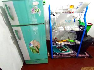 a refrigerator with its door open with dishes inside at Ramesh Guesthouse in Mirissa