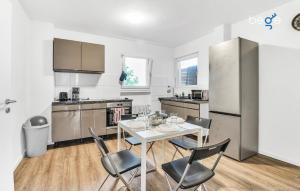 a kitchen with a table and chairs in a room at BEGE APARTMENTS Work Comfort in Herten