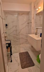 a bathroom with a toilet and a sink and a shower at ONE LMC LUXURY Apartments Private Parking,EV 16kwh in Craiova