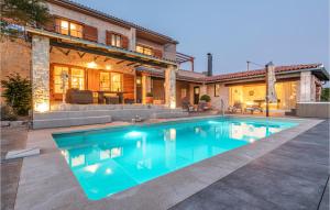 a swimming pool in front of a house at Lovely Home In Jadrija With Wifi in Jadrija