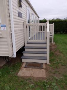 a house with a staircase leading to a house at Happy Havan in Great Yarmouth