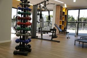a gym with several treadmills and weights at Cosy Studio Apartament - Arujá SP in Arujá