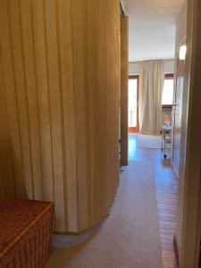 a hallway with wooden walls and a room with a table at Sestriere Gem Comfy Apartment with Ski Views in Sestriere