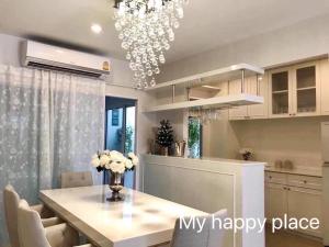 a kitchen and dining room with a chandelier at My Happy Place in Nonthaburi
