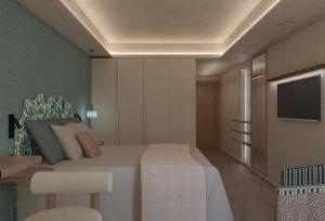 a bedroom with a bed and a tv on a wall at Rodos Park in Rhodes Town