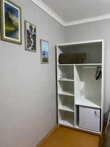 a white book shelf in a room at Pousada dos Pássaros in Gramado