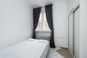 a bedroom with a bed and a window at Affordable Stay Navratilova in Prague