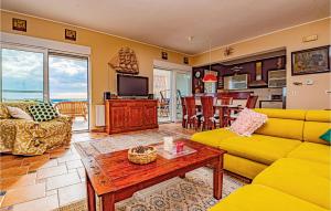 a living room with a yellow couch and a table at Awesome Home In Zaboric With Wifi in Zaboric