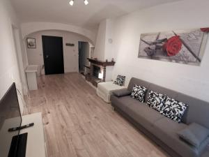 a living room with a couch and a fireplace at Casa del barbiere in Dogliani