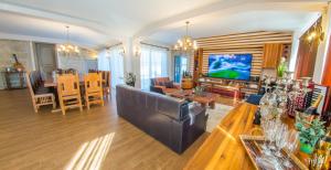a living room with a couch and a dining room at Residence Herzegovina in Široki Brijeg