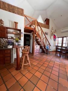 a kitchen and dining room with a staircase in a house at Cabañas La Casa de Pucha in Pedasí Town