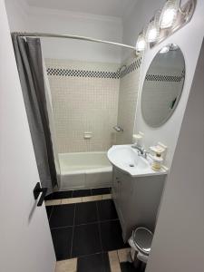 a bathroom with a sink and a tub and a mirror at Luxury Boutique Home - 5 Beds 2 Baths 25 minutes to NYC in Jersey City +32 photos
