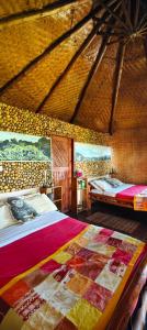 a large room with two beds and a bathroom at Agandi Uganda Eco-lodges in Bwindi