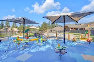 a playground with tables and umbrellas at a park at Yellow Pine 36 in Sunriver