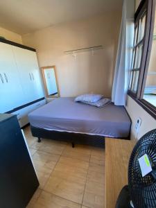 a small bedroom with a bed and a window at Apartamento em Torres RS in Torres +16 photos