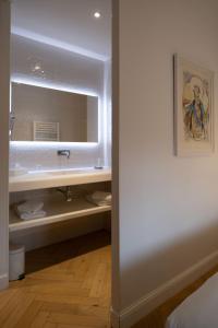 a bathroom with a sink and a mirror at Hôtel le XIX in Béziers +60 photos