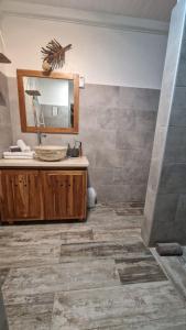 a bathroom with a sink and a mirror at Caraib'Bay Hotel in Deshaies +35 photos