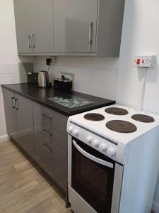 a white stove top oven in a kitchen at Home from Home in Faversham