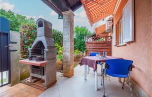 a patio with a table and a wood stove at Lovely Apartment In Banjole With Wifi in Banjole
