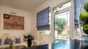 a living room with a door and a window at Diamond Apartments & Suites in Hersonissos