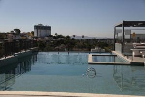 a large swimming pool with a pool noodle in the water at Cosy Studio Apartament - Arujá SP in Arujá