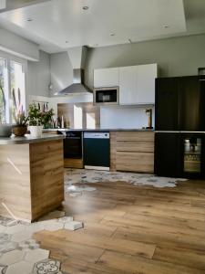 a kitchen with a floor that has been ripped up at La Maison aux pieds des Pyrénées - Piscine d'exception de 25m in Espoey