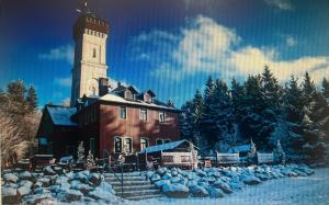 a large building with a clock tower in the snow at Hinter der Alten Post in Annaberg-Buchholz