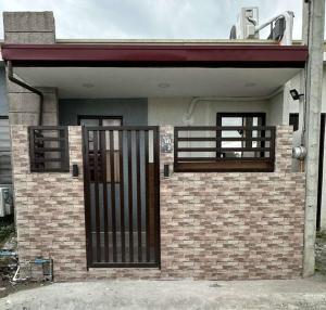 a house with a gate and a brick building at Noble Villa in Pila