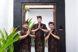 a group of men standing in front of a mirror praying at Maisaba Seminyak Loft & Villas in Seminyak +39 photos
