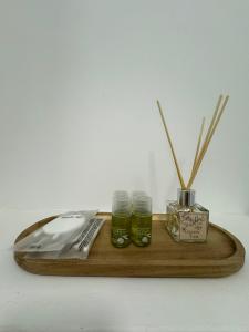 a wooden tray with two glasses and two sticks at Private Heaven at Central Park in Galaţi +3 photos