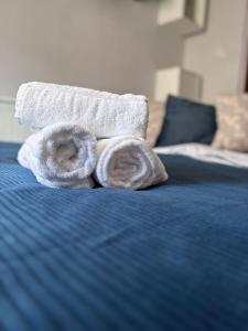a pile of towels sitting on top of a bed at Tiny Studio Universitate in Craiova +32 photos