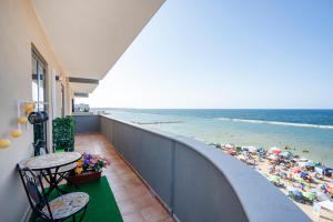 a balcony with a view of a beach with umbrellas at Approdo Sul Mare Bari Apartment in Bari