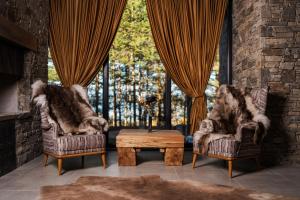 two chairs and a coffee table in a living room at Brentas Spa Resort in Tsigov Chark