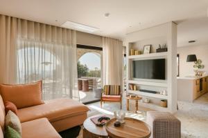 a living room with a couch and a table at Kerami Kefalonia in Kefallonia