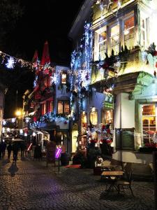 a city street decorated with christmas lights at night at Adonis Hotel Strasbourg in Strasbourg