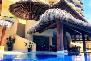 a resort with a swimming pool with a resort at Palmetto 2-story Luxury condos in Ixtapa
