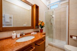 a bathroom with a sink and a shower at Approdo Sul Mare Bari Apartment in Bari +31 photos