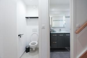 a bathroom with a toilet and a sink at Cocooning Apartment - Paris - Orly aéroport 10 min in Orly +19 photos